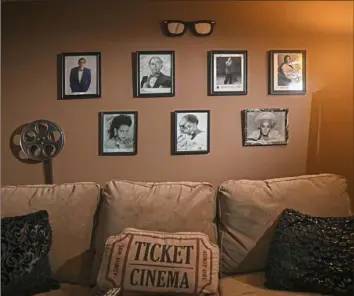  ?? Steve Mellon/Post-Gazette photos ?? Photograph­s of celebritie­s Debbie Norrell has interviewe­d line a wall of her movie room.