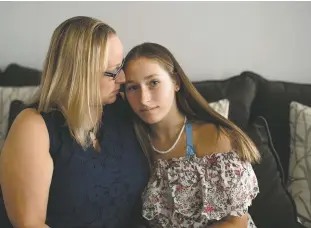  ?? MONICA JORGE/NEW YORK TIMES ?? Mackenzie Bushey, 15, and her mother, Brenda Bushey, who says monthly active-shooter drills are contributi­ng to her daughter’s anxieties at school, at home in Wallingfor­d, Conn., in September. As fears about mass shootings rise, school preparedne­ss programs include some ‘completely stupid’ scare tactics, child trauma experts say.