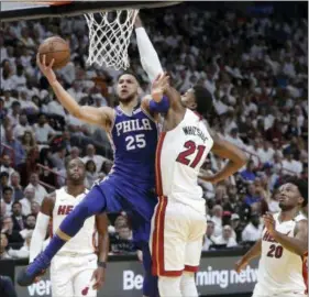  ?? LYNNE SLADKY — THE ASSOCIATED PRESS ?? Philadelph­ia 76ers’ Ben Simmons (25) goes up for a basket as Miami Heat’s Hassan Whiteside (21) defends during the first half of Game 3 of a first-round NBA basketball playoff series Thursday in Miami.