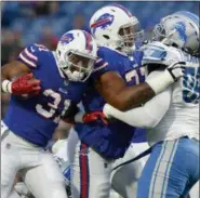 ?? ADRIAN KRAUS — THE ASSOCIATED PRESS FILE ?? In this file photo, Buffalo Bills running back Jonathan Williams (31) follows the block of tackle Cordy Glenn (77) against Detroit Lions defensive tackle Khyri Thornton (99) during the first half of a preseason NFL football game in Orchard Park, N.Y. A...