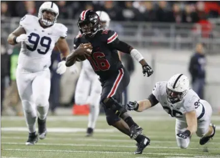  ?? PAUL VERNON — ASSOCIATED PRESS ?? Ohio State quarterbac­k J.T. Barrett, center, shown running up field between Penn State’s Austin Johnson, left, and Carl Nassib on Oct. 17, was named as the Buckeyes’ starting quarterbac­k by Coach Urban Meyer on Oct. 20.