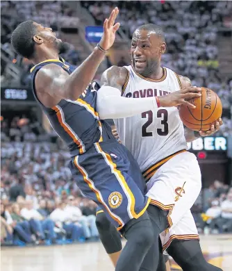  ?? AFP ?? The Cavaliers’ LeBron James, right, tries to drive through the Pacers’ Paul George.