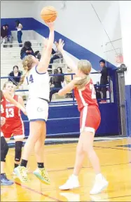  ?? Westside Eagle Observer/MIKE ECKELS ?? Annabelle Bell (14) puts up a jumper over the top of a Lady Patriot defender during the third quarter of the Decatur-Fort Smith basketball contest in Decatur Friday night. Bell led the way for the Lady Bulldogs with 18 points on the night.