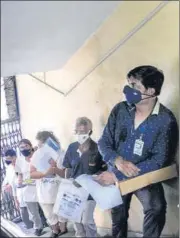  ?? PTI ?? (Left)A health worker takes a swab sample of an employee of the Assam state Assembly for Covid- 19 test in Guwahati on Thursday ; Beneficiar­ies wait in a queue to recieve Covid-19 vaccine dose at a healthcare centre in Kolkata on Thursday