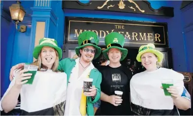  ?? HANNAH PETERS/ GETTY IMAGES FILES ?? Partygoers get into the spirit of St. Patrick’s Day at a bar in New Zealand. Despite the hype, most Canadians are intending to stay at home, and only 39 per cent will mark the day by drinking alcohol.