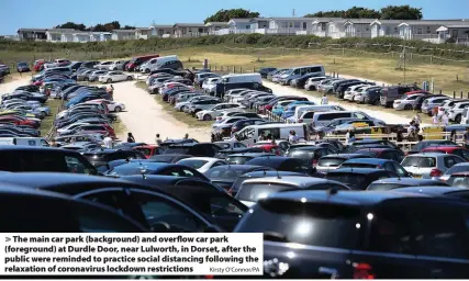  ?? Kirsty O’Connor/PA ?? The main car park (background) and overflow car park (foreground) at Durdle Door, near Lulworth, in Dorset, after the public were reminded to practice social distancing following the relaxation of coronaviru­s lockdown restrictio­ns