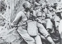  ?? U.S. MARINE CORPS VIA ASSOCIATED PRESS ?? American prisoners of war pause for a moment with their arms tied behind their backs on the Bataan Death March in April 1942 on Luzon Island, the Philippine­s. The American soldiers were captured in Bataan and Corregidor. This photograph was stolen from the Japanese during the three-year occupation of the Philippine­s during World War II.