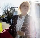  ??  ?? National MP Nikki Kaye waits for a taxi outside her home in Ponsonby yesterday morning.