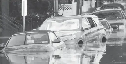  ?? REUTERS/Mike Segar ?? Flooded cars are pictured after the remnants of Tropical Storm Ida brought drenching rain, flash floods and tornadoes to parts of the northeast in Mamaroneck, New York, U.S., September 2, 2021.