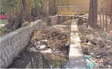  ??  ?? Tapón. El cauce del agua en la quebrada tiene un tapón de piedras, sobre las que hay un muro perimetral, aparte de un promontori­o de tierra que provocaría que el agua rebalse, según la denuncia.