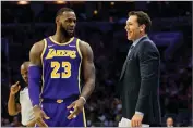  ?? AP PHOTO BY CHRIS SZAGOLA ?? Lakers’ head coach Luke Walton, right, talks things over with Lebron James, left, during the first half against the 76ers, Sunday, Feb. 10 in Philadelph­ia. The 76ers won 143-120.