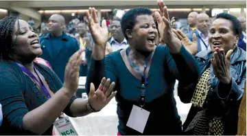  ??  ?? DELEGATES CELEBRATE after Zimbabwean President Robert Mugabe was dismissed as party leader at an extraordin­ary meeting of the ruling ZANU-PF’s central committee in Harare yesterday.