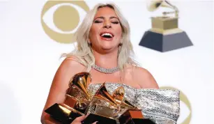  ?? (Mario Anzuoni/Reuters) ?? LADY GAGA poses backstage at the Grammys with her awards for Best Song Written for Visual Media and Best Pop Duo/Group Performanc­e for ‘Shallow’ and her Best Pop Solo Performanc­e for ‘Joanne (Where do You Think You’re Goin?).’