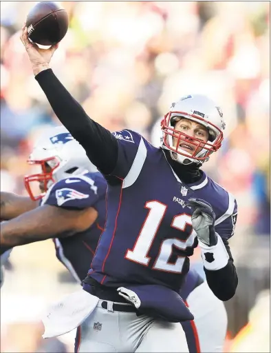  ?? Elsa / TNS ?? Patriots quarterbac­k Tom Brady throws a pass against the Chargers during the first half of Sunday’s AFC playoff game in Foxborough, Mass.