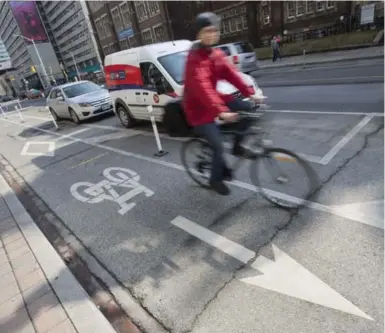  ?? BERNARD WEIL/TORONTO STAR ?? City councillor­s Joe Cressy and Mike Layton say the pilot project showed bike lanes were a significan­t move toward safety.