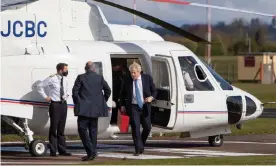  ?? Photograph: Paul Bunch/Alamy ?? Boris Johnson steps off a helicopter at Wolverhamp­ton Halfpenny Green airport.