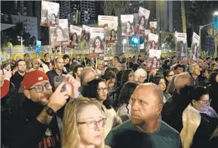  ?? LEO CORREA AP PHOTOS ?? People hold signs showing a picture of a hostage during a demonstrat­ion Saturday in Tel Aviv, Israel, calling for the release of the hostages taken by Hamas militants during the Oct. 7 attack.