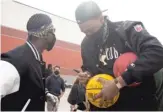  ??  ?? Former Chicago high school star Jabari Parker, now with the Sacramento Kings, signs a ball Saturday at a food drive in the Pullman neighborho­od.