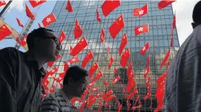  ?? Picture / AP ?? China and Hong Kong flags fly as Hong Kong counts down to the celebratio­ns marking the 20th anniversar­y of its handover.