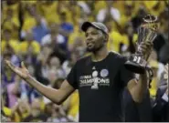  ?? MARCIO JOSE SANCHEZ - THE ASSOCIATED PRESS ?? In this June 12, 2017, file photo, Golden State Warriors forward Kevin Durant gestures as he holds the Bill Russell NBA Finals Most Valuable Player Award after Game 5 of basketball’s NBA Finals between the Warriors and the Cleveland Cavaliers in...