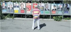  ?? — Reuters ?? A man looks at campaign posters of 11 candidates who run in the 2017 French presidenti­al election in Saint Andre de La Roche, near Nice.