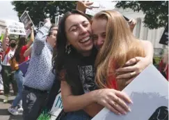  ?? AP PHOTO/JOSE LUIS MAGANA ?? Anti-abortion protesters celebrate Friday in Washington after the news that the Supreme Court overturned Roe v. Wade. The Supreme Court has ended constituti­onal protection­s for abortion that had been in place nearly 50 years, a decision by its conservati­ve majority to overturn the court’s landmark abortion cases.