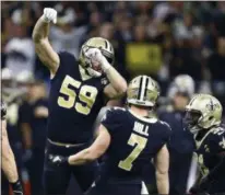  ?? BUTCH DILL - THE ASSOCIATED PRESS ?? New Orleans Saints quarterbac­k Taysom Hill (7) celebrates his first down carry on a fake punt, with linebacker Vince Biegel (59) in the first half of an NFL divisional playoff football game in New Orleans, Sunday, Jan. 13, 2019.