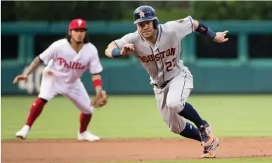  ?? Associated Press ?? n Houston Astros' Jose Altuve runs toward third base on the ground out by Derek Fisher during the first inning of a baseball game against the Philadelph­ia Phillies on Wednesday in Philadelph­ia.