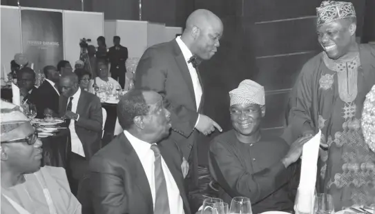 ??  ?? From left: Commission­er for Tourism and Inter-Government­al Relations, Lagos State, Mr. Oladisun Holloway; Chairman, Ecobank Nigeria, Dr. Sonny Kuku; and Governor Babatunde Raji Fashola (SAN) exchanging pleasantri­es with Group ED, Domestic Bank, Ecobank...