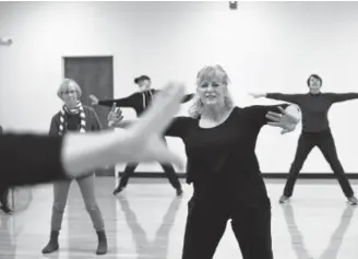  ??  ?? Parkinson’s disease patient Karen Talcott, center foreground, takes part in a Reconnect with Your Body dance class at the Arvada Apex Center. She previously trained as a boxer, but she was forced to quit because of an injury.