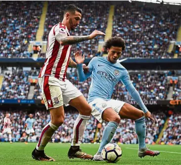  ?? — AFP ?? Eyes on the ball: Manchester City midfielder Leroy Sane (right) holding off Stoke defender Erik Pieters during the English Premier League match at the Etihad yesterday.