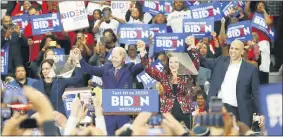  ?? PAUL SANCYA — THE ASSOCIATED PRESS ?? In this March 9 photo, from left, Sen. Kamala Harris, D-Calif., Democratic presidenti­al candidate former Vice President Joe Biden, Gov. Gretchen Whitmer, and Sen. Cory Booker D-N.J. greet the crowd during a campaign rally at Renaissanc­e High School in Detroit.