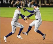  ?? WILL NEWTON / GETTY IMAGES ?? Carlos Correa (left) and George Springer of the Astros celebrate their team’s 8-1 win against the Nationals in the World Series on Saturday.