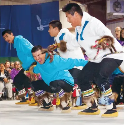  ??  ?? Jimmy Kalinek performs with the Inuvik Drummers and Dancers, 2014 COURTESY TUSAAYAKSA­T MAGAZINE