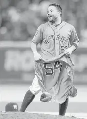  ?? Karen Warren photos / Houston Chronicle ?? Jose Altuve parades around with a souvenir — Mike Fiers’ jersey — following Fiers’ pitching feat.