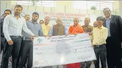  ?? DEEPAK GUPTA/ HT PHOTOS ?? Governor Ram Naik giving cheques to the beneficiar­y startups during the inaugural function of the Kalam Centre for Innovation and Incubation of Startups at AKTU. (Below) The Dreamathon photo and poster gallery at the university.