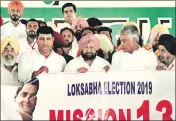  ?? SANJEEV KUMAR/HT ?? ■ Punjab CM Captain Amarinder Singh and PPCC chief Sunil Jakhar release ‘Mission 13’ poster at Killianwal­i in Lambi assembly segment on Sunday. The poster marks the launch of the party’s Lok Sabha campaign in the state.