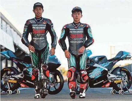  ??  ?? Petronas Sprinta Racing’s Adam Norrodin (left) and Sasaki finished 21st and 19th respective­ly in the Moto3 at the German GP on Sunday.