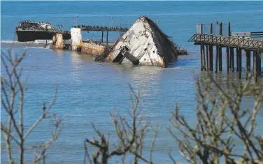  ?? Michael Macor / The Chronicle ?? The huge stern of the Cement Ship, originally the Palo Alto, lies on its side just offshore at Seacliff State Beach in Aptos (Santa Cruz County). Battered by winter storms, the boat is in pieces.