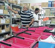  ?? SIBONELO NGCOBO
African News Agency (ANA) ?? PRANESH Behari, chief executive of Alert Stationers, and employee Sphumelele Mkhize prepare stationery orders. |