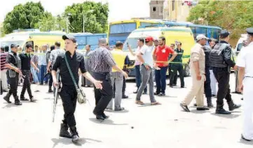  ??  ?? Police and people stand near the scene of a foiled suicide attack in Luxor, Egypt. — Reuters photo