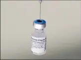  ?? ?? A syringe is placed into a vial of Pfizer-BioNTech vaccinatio­n at a COVID-19 clinic in Augusta, Maine, on Dec 21, 2021. On Oct 20, 2022, Pfizer said it will charge $110 to $130 for a dose of its COVID-19 vaccine once the US government stops buying the shots, but the drugmaker says it expects many people will continue receiving doses for free. (AP)