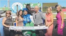  ??  ?? Connection­s of Tziporah celebrate with jockey Jason Maskiell after their win at Aquis Park on Saturday.