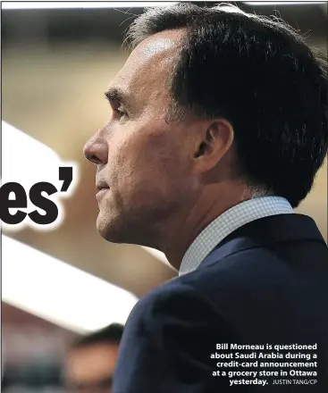  ?? JUSTIN TANG/CP ?? Bill Morneau is questioned about Saudi Arabia during a credit-card announceme­nt at a grocery store in Ottawa yesterday.