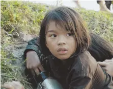 ??  ?? DARK CHAPTER: ‘First They Killed My Father,’ directed by Angelina Jolie, chronicles the experience­s of Loung (Sareum Srey Moch, above), who survived the genocidal rule of Pol Pot and the Khmer Rouge in Cambodia.