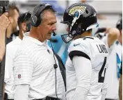  ?? ASSOCIATED PRESS ?? Former Jacksonvil­le Jaguars coach Urban Meyer talks with kicker Josh Lambo after Lambo missed his second field goal against the Broncos last September. A lawsuit claims Meyer abused Lambo.