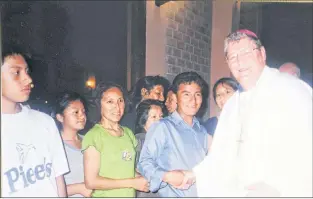  ?? SUBMITTED PHOTO ?? Archbishop Martin Currie (right) greets people on a visit to Peru.