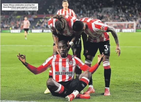  ?? JUSTIN SETTERFIEL­D/GETTY IMAGES ?? Yoane Wissa celebrates scoring the third Brentford goal against Liverpool