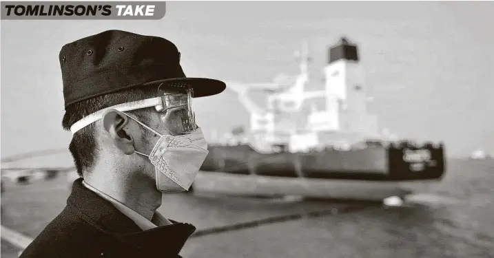  ?? AFP via Getty Images ?? Above, a police officer keeps watch as a Kuwaiti oil tanker unloads crude in China’s eastern Shandong province.