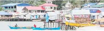  ?? @tribunephl_rio PHOTOGRAPH BY RIO DELUVIO FOR THE DAILY TRIBUNE ?? PEOPLE who live on stilts near the sea at Punta Bilang-Bilang, Surigao City prepare for a coming storm.